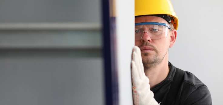 Contractor assessing the improved quality of work after implementing types of drywall taping and mudding automation