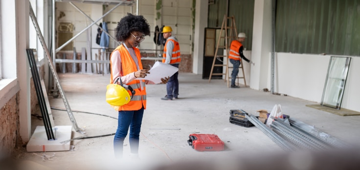 Construction worker ensuring building processes incorporate fire-resistant drywall construction trends