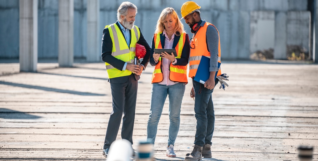 Construction development team assessing the activity of concrete robots