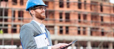 Engineer seeing the advantages of robots in construction as he visits a worksite