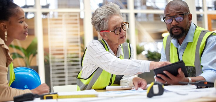 Construction professionals discussing what they need from construction layout equipment for a current project