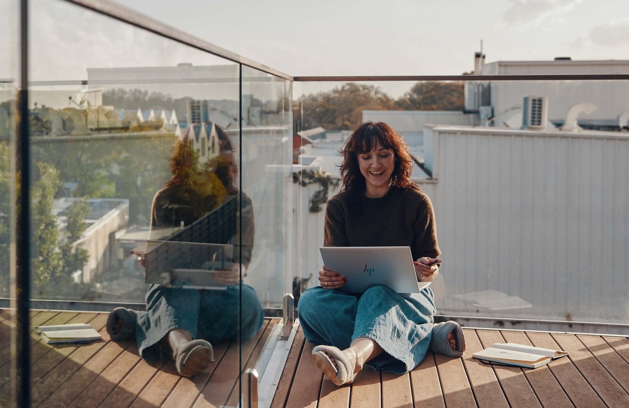 Woman working on an HP laptop from her patio.