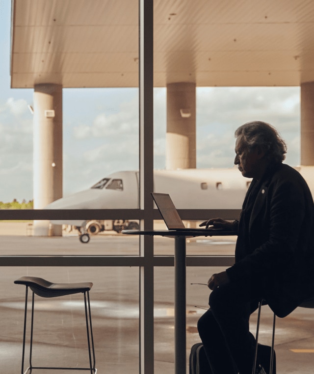 Man works on HP laptop at airport
